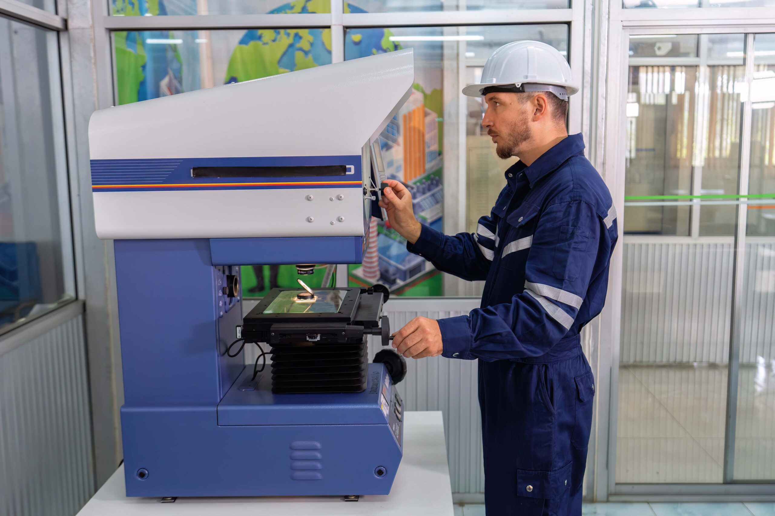 An engineer using optical micrometer quality checking micro part
