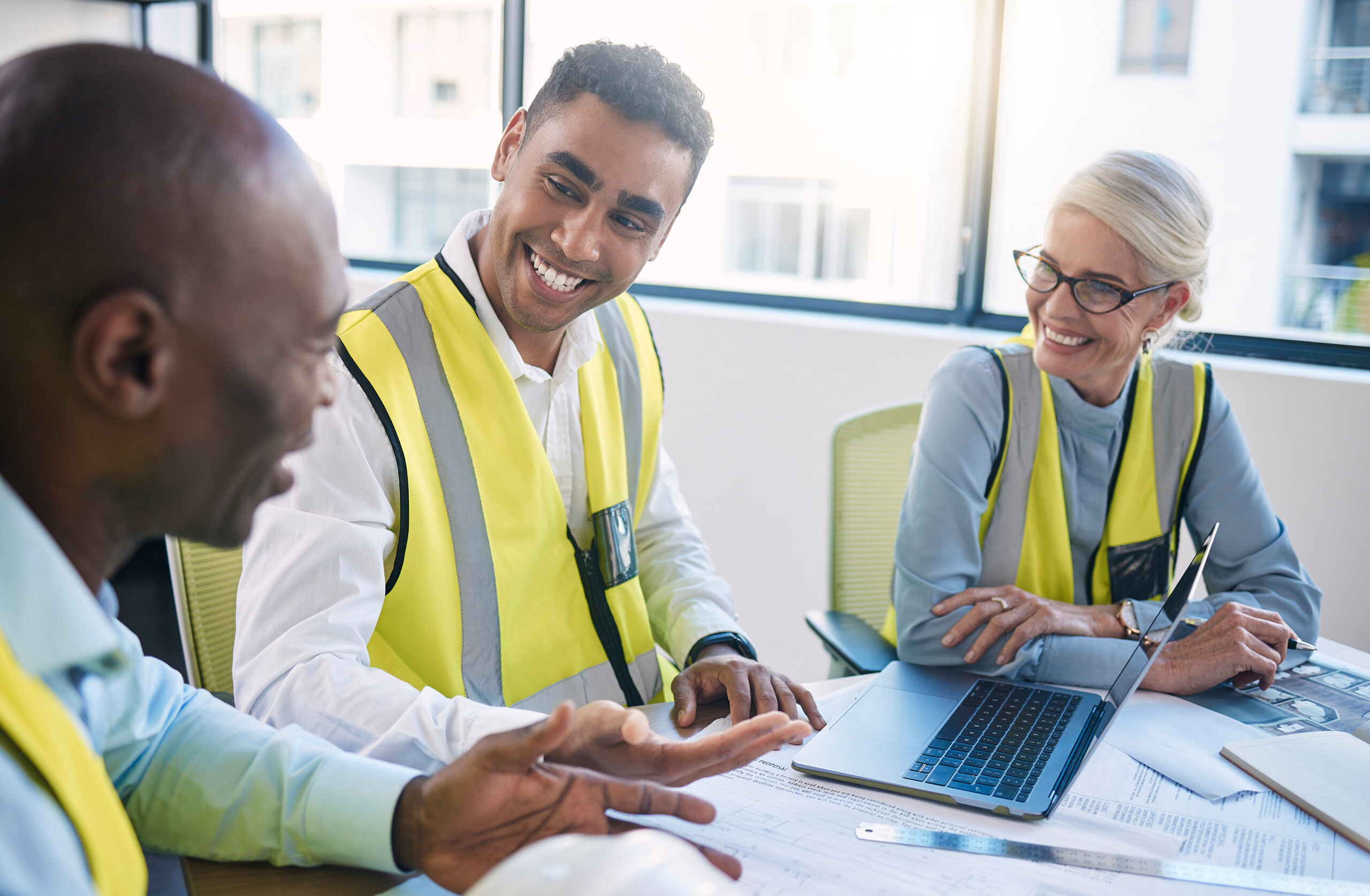 Architect, laptop and meeting for industrial construction, team planning or idea strategy at office.