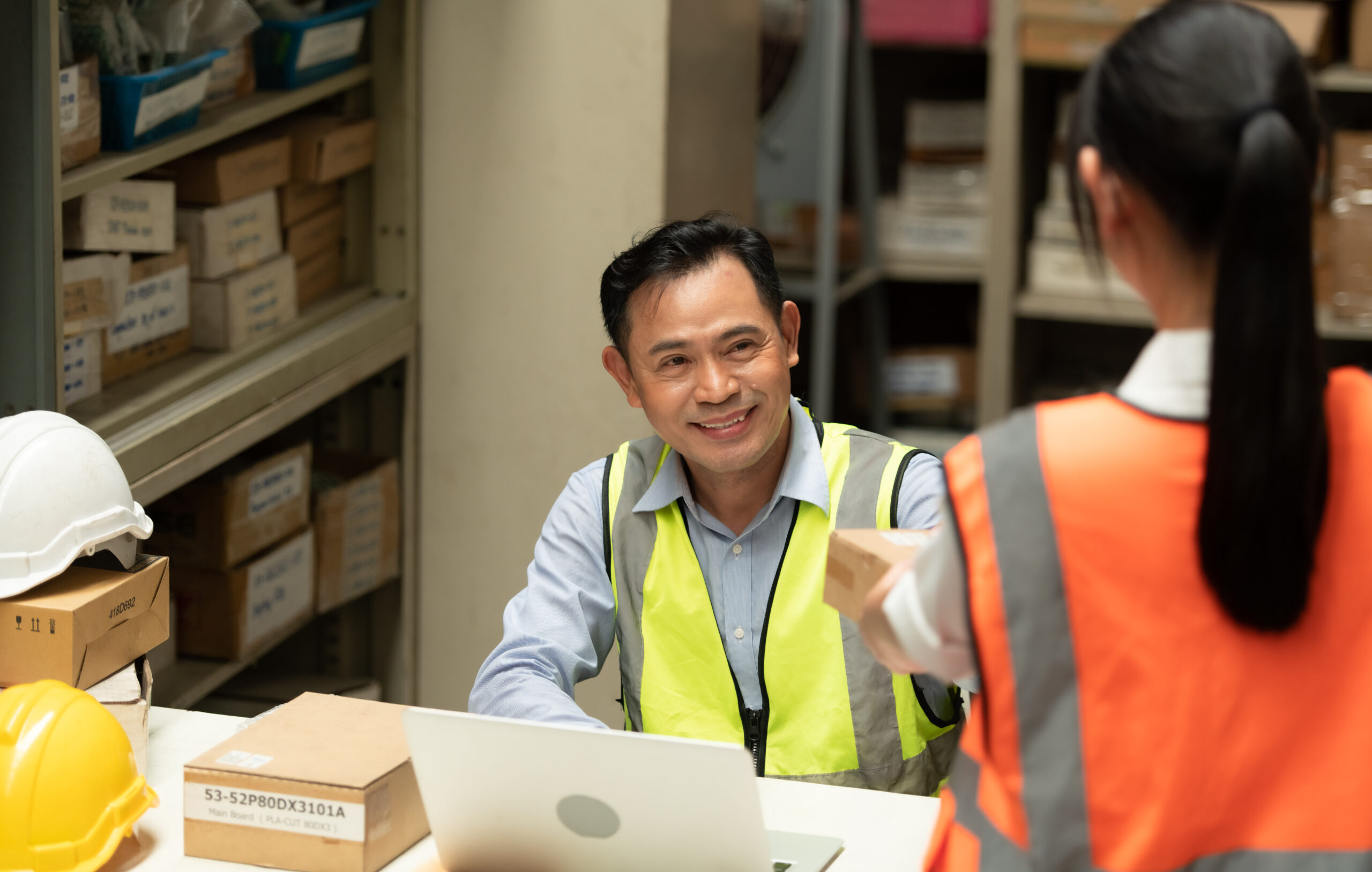 Warehouse Manager with female assistant Rethink a plan to prepare items that need to be sold to retailers during times of higher market prices.