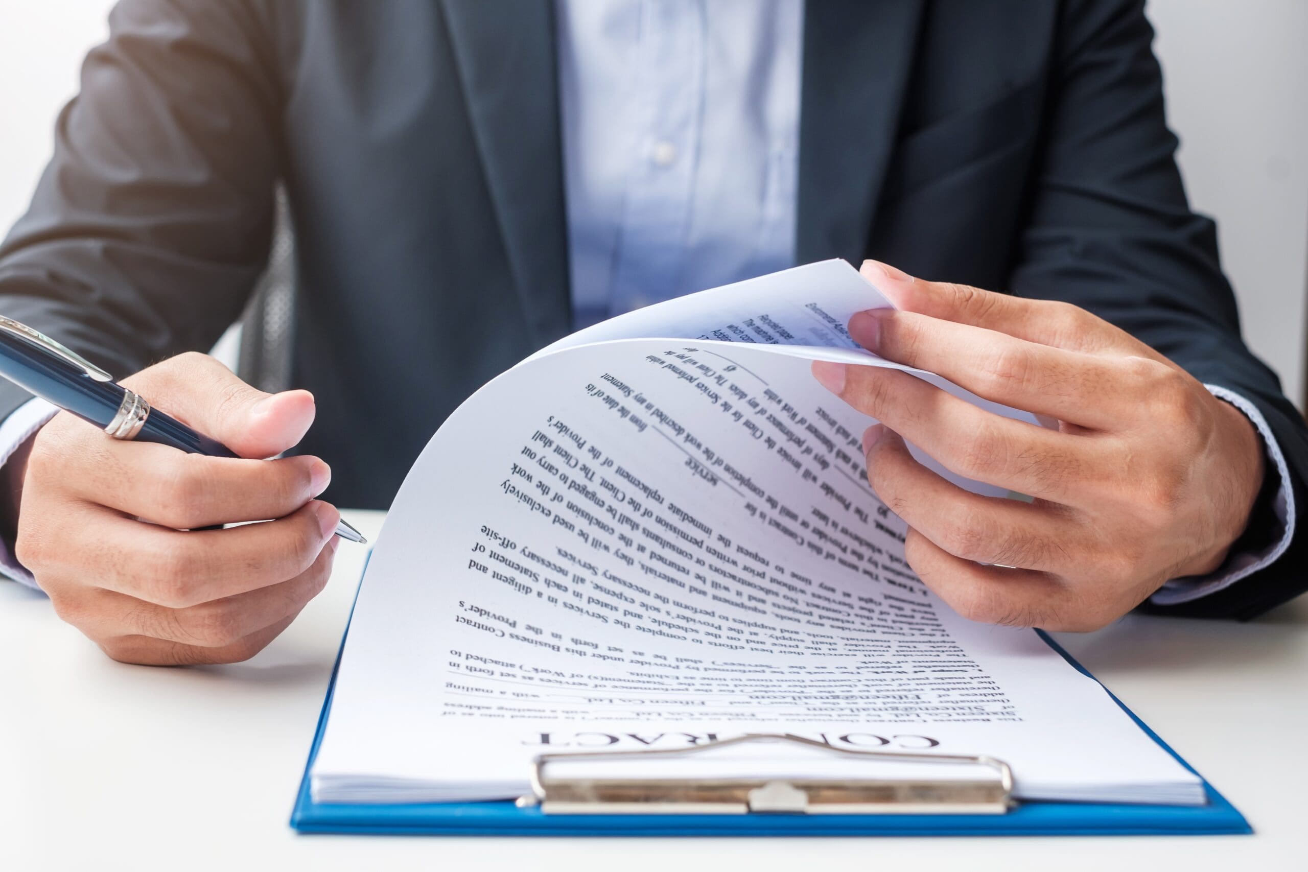 Businessman signing on contract documents after reading, man holding pen and approve on business report. Contract agreement, partnership and deal concepts