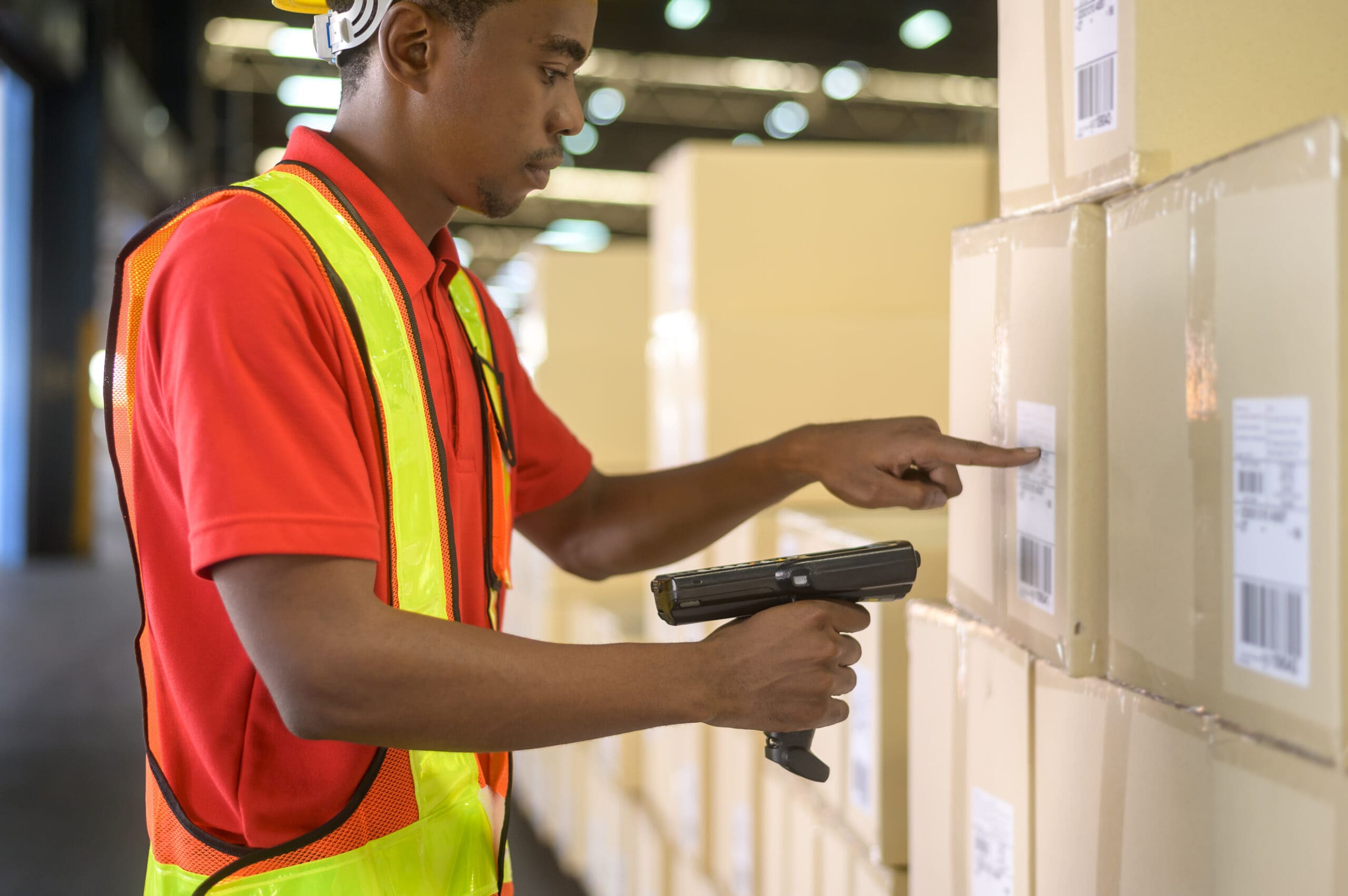 Worker scanning parcels for retail and transport shipping